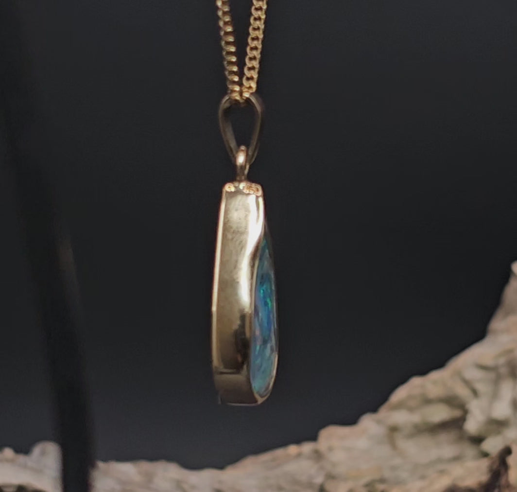 Video showing the boulder opal and gold pendant turn 180 degrees.
