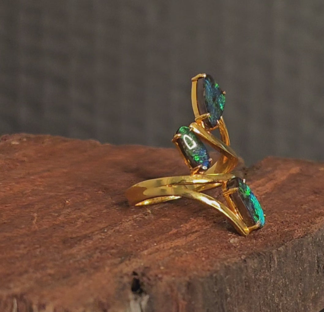 Video showing the triad opal and gold ring rotate 180 degrees.