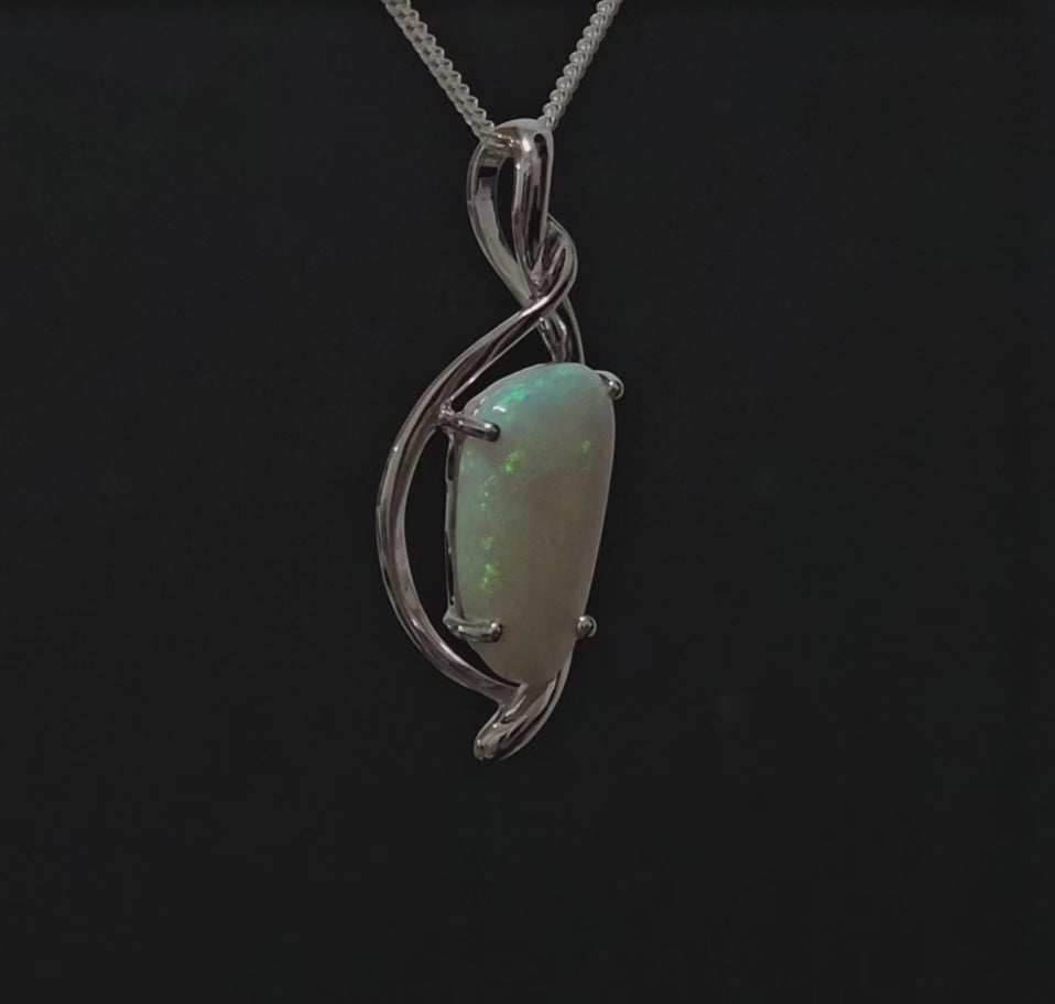 Large green-coloured light opal set in a stylish silver pendant.