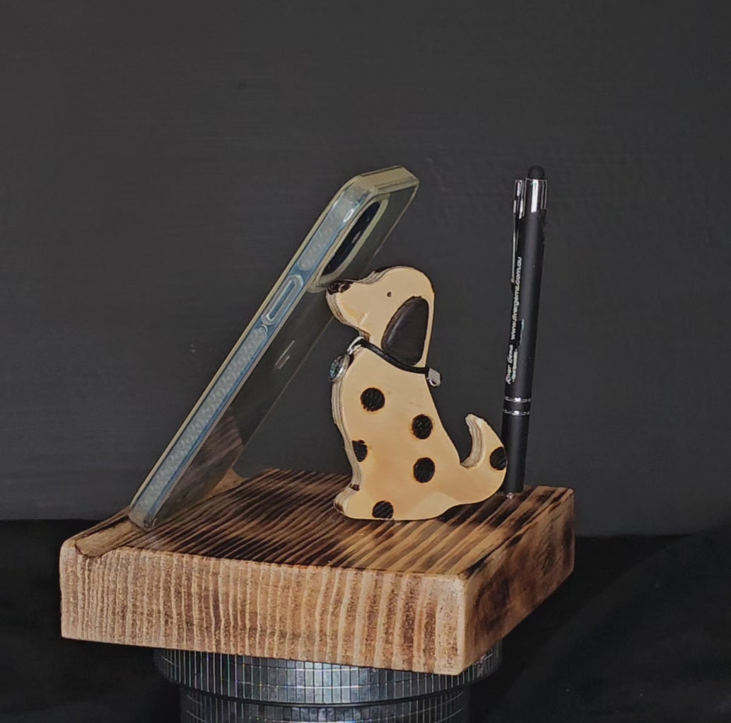 Wooden tablet stand with spotted dog and pen shown to rotate 180 degrees.