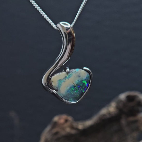 Video showing the boulder opal sterling silver necklace rotate providing a view of the front and back of the pendant.