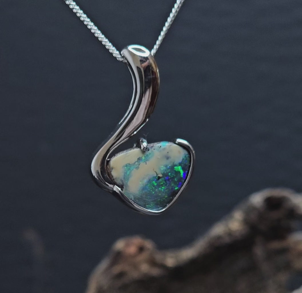 Video showing the boulder opal sterling silver necklace rotate providing a view of the front and back of the pendant.