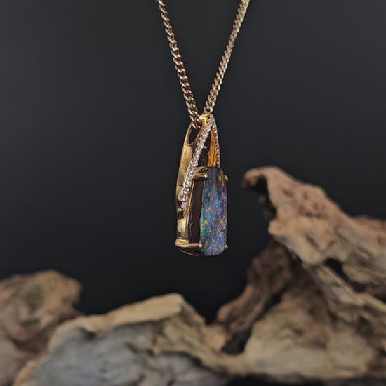 Video showing the boulder opal and diamonds yellow gold pendant rotate to show 200 degree view.