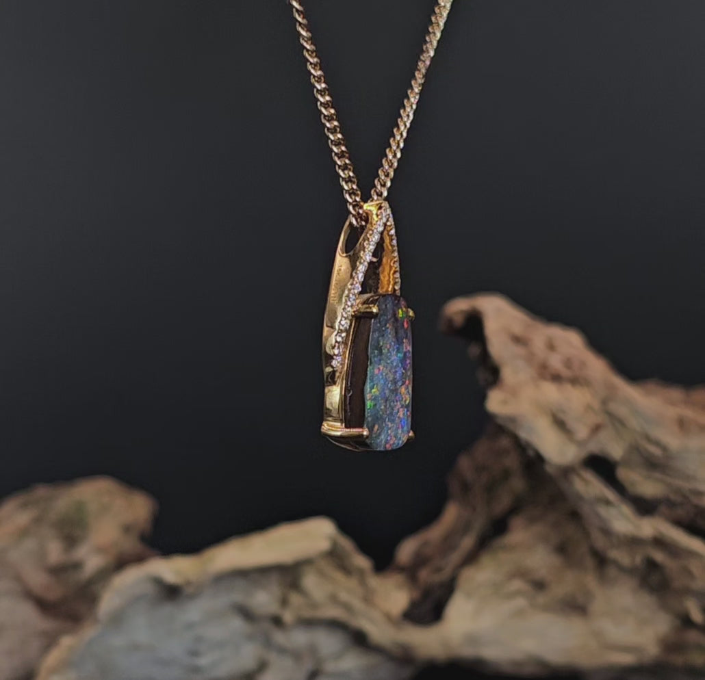 Video showing the boulder opal and diamonds yellow gold pendant rotate to show 200 degree view.