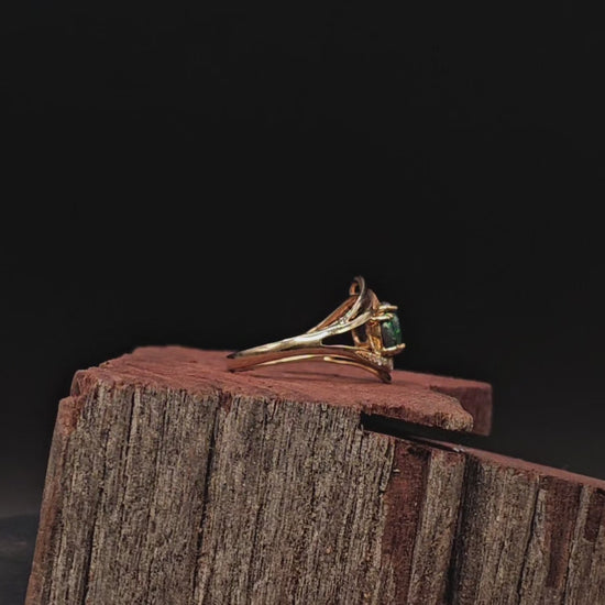 Video showing yellow gold ring with 3 oval shaped black opals rotate to show 200 degree view.
