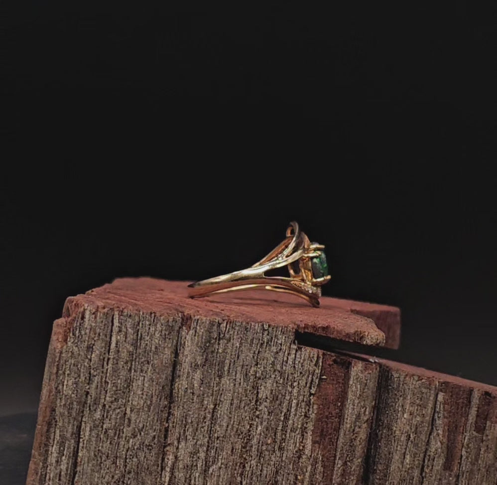 Video showing yellow gold ring with 3 oval shaped black opals rotate to show 200 degree view.