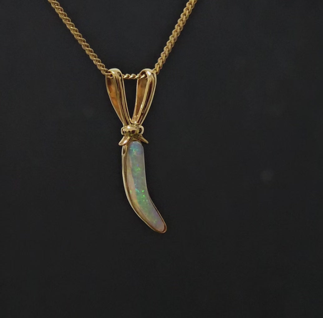 Cute carrot looking gold neclace design with long light opal as the feature.