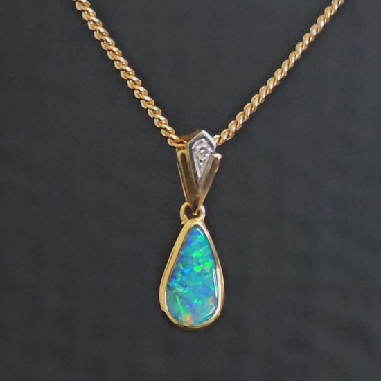 Video showing gold opal pendant rotate to reveal both sides of the pendant. The back shows the ironstone of the boulder opal. The side shows the large bail opening which would allow any gold chain to easily pass through.