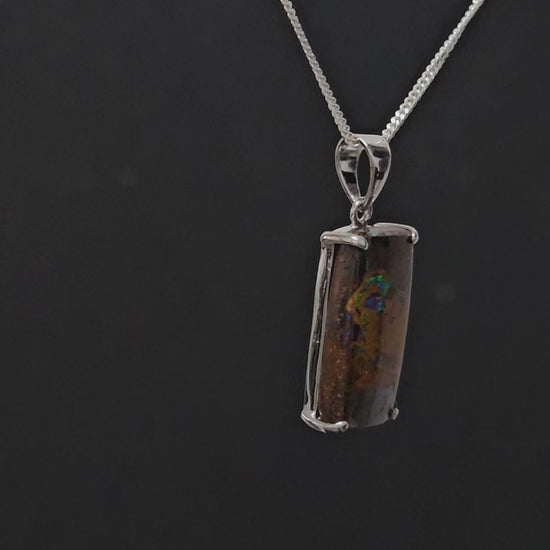 Rectangular earth toned necklace with veins of colour set in silver.