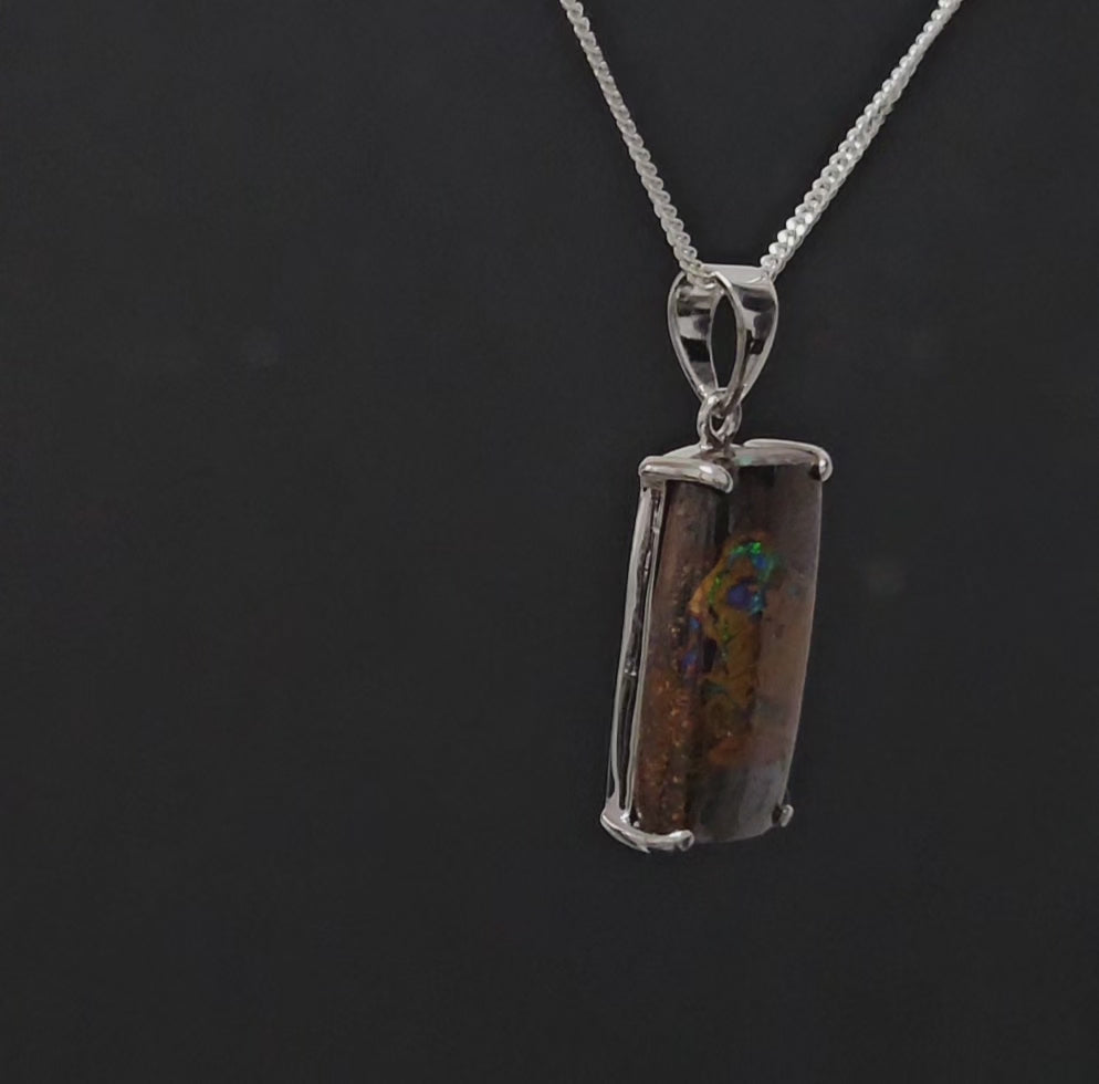 Rectangular earth toned necklace with veins of colour set in silver.