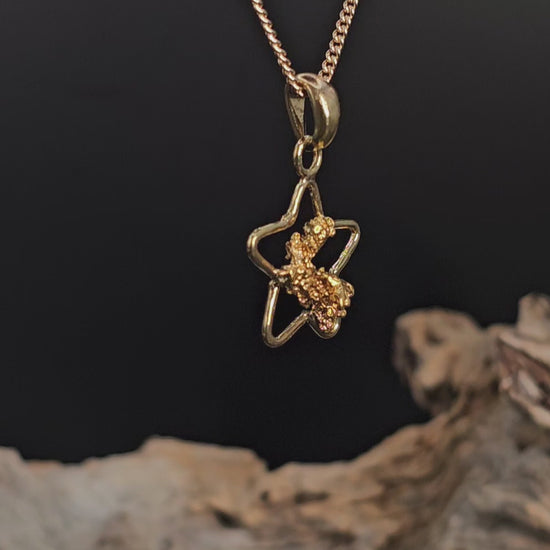 Video showing gold nugget in star shaped pendant rotate 180 degrees.