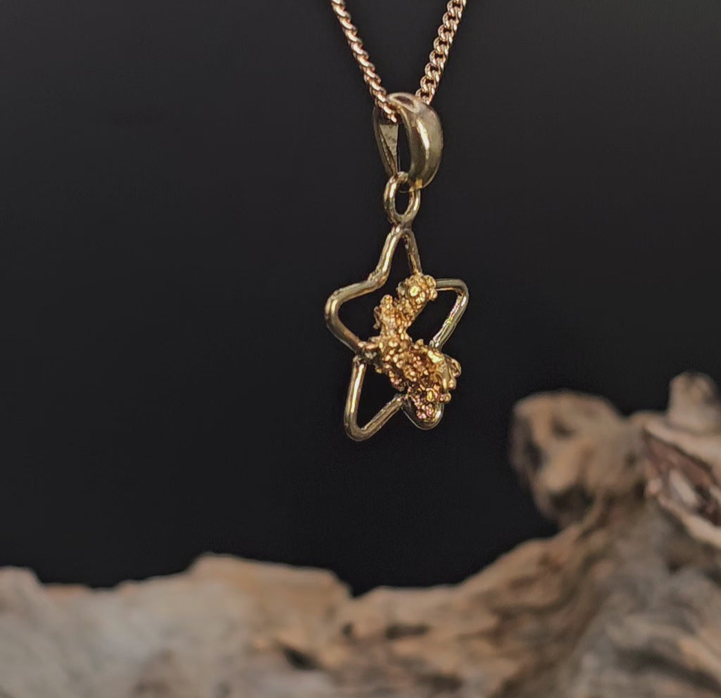 Video showing gold nugget in star shaped pendant rotate 180 degrees.