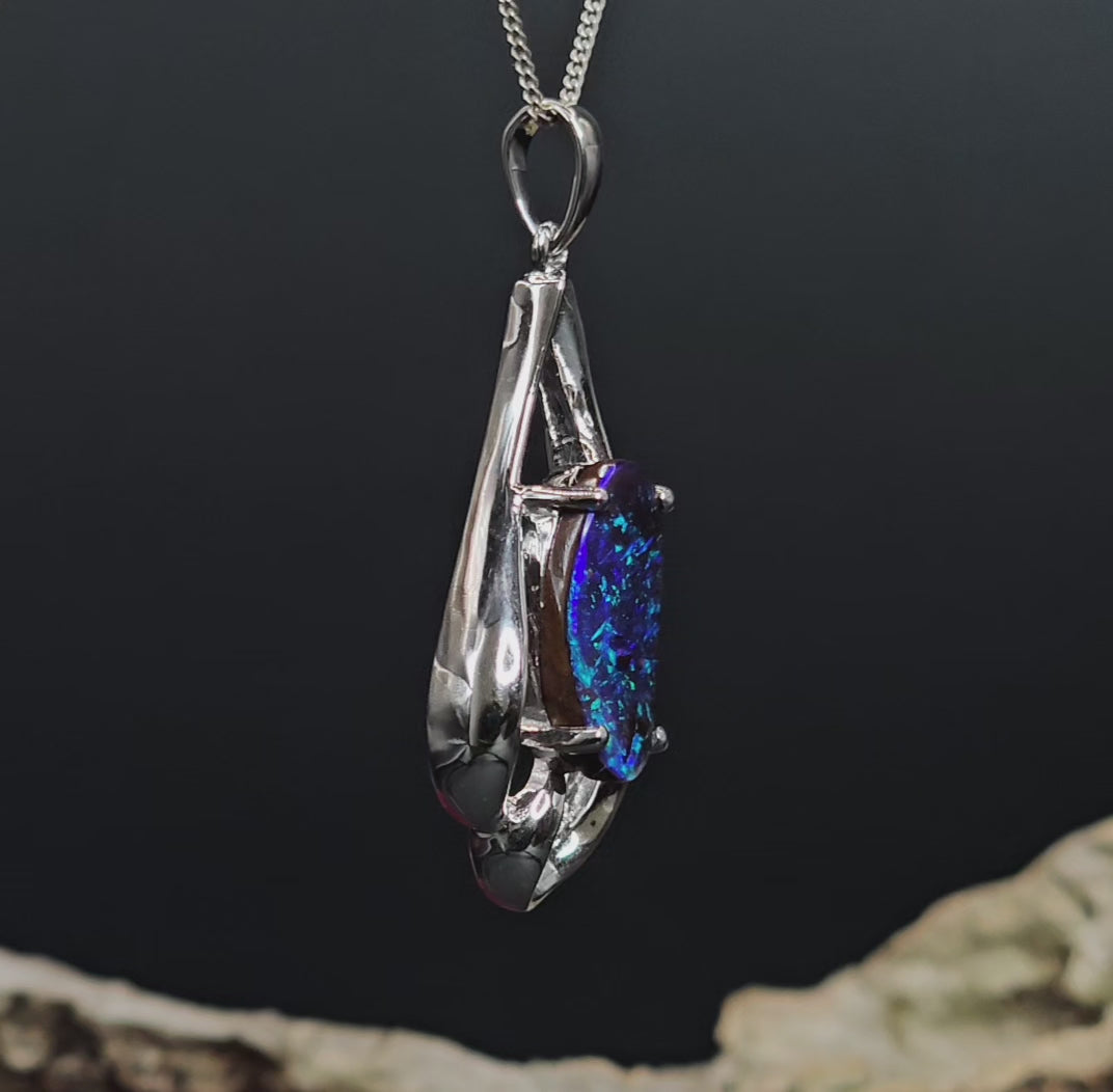 Video showing the boulder opal white gold pendant rotate to show side, front and rear views.