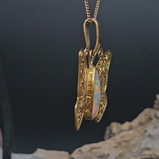 Video showing the gold necklace in the form of a butterfly with gold nugget wings and boulder opal body rotate 180 degrees.