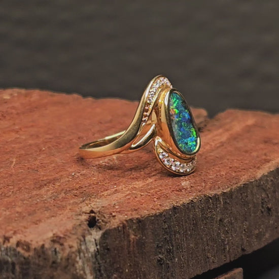 Video showing the boulder opal and diamonds gold ring rotate 200 degrees.
