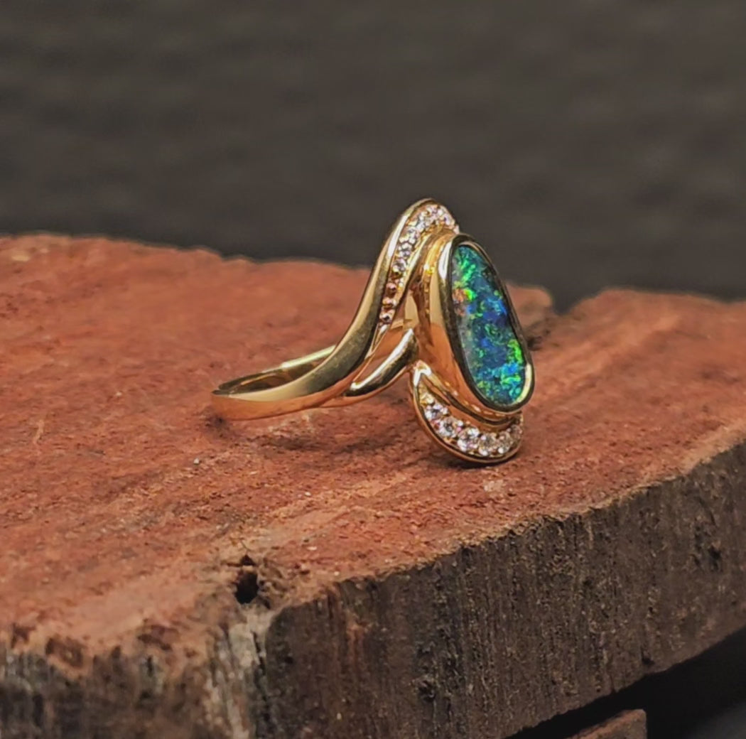 Video showing the boulder opal and diamonds gold ring rotate 200 degrees.