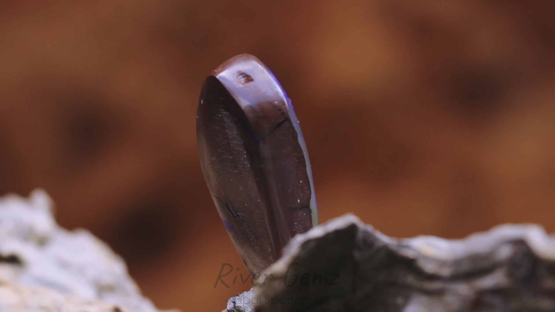 Video shows a 180 degree rotation of the solid boulder opal.