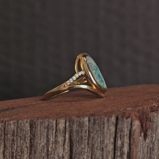 Video showing the yellow gold boulder opal and diamonds ring rotate 180 degrees.