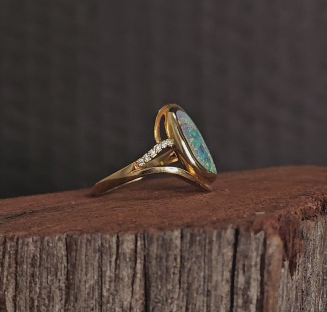 Video showing the yellow gold boulder opal and diamonds ring rotate 180 degrees.