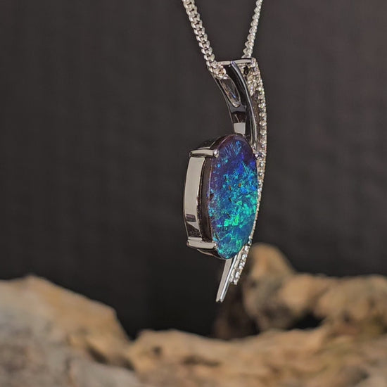 Video showing white gold pendant with opal and diamonds rotate.