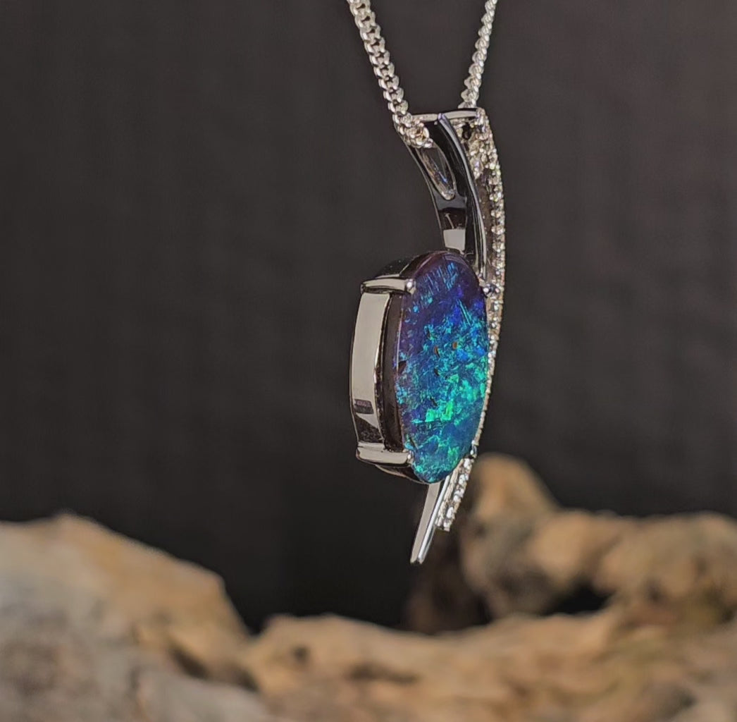 Video showing white gold pendant with opal and diamonds rotate.