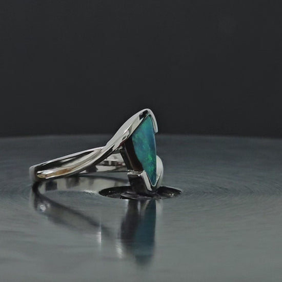 Triangular shaped dark opal shown rotating 300 degrees in the video.