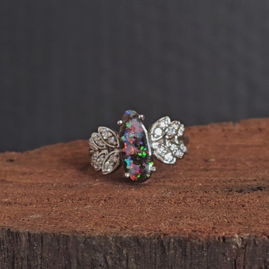 Video showing the white gold, boulder opal and diamond ring rotate 180 degrees.
