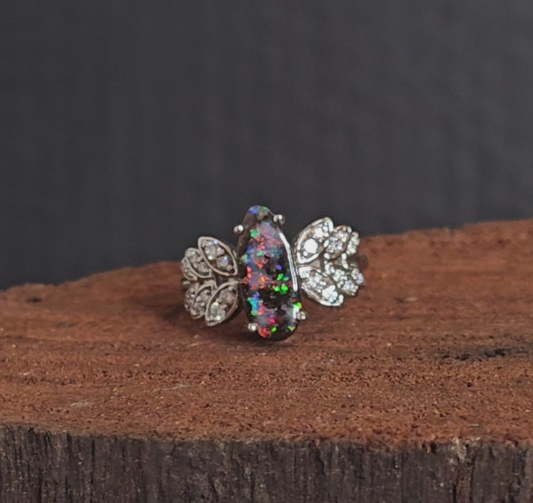 Video showing the white gold, boulder opal and diamond ring rotate 180 degrees.