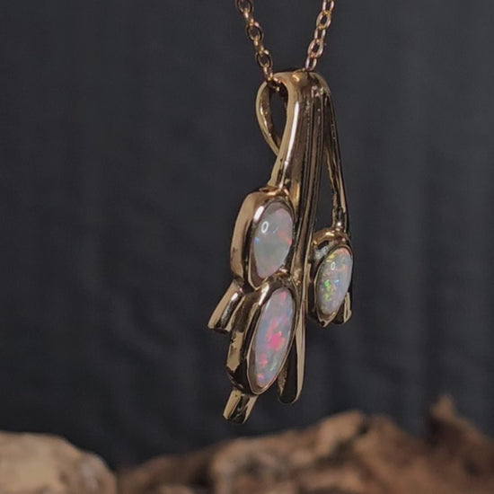 Video showing the light opal gold pendant rotate 180 degrees.