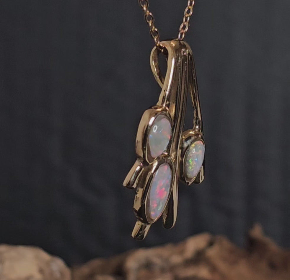 Video showing the light opal gold pendant rotate 180 degrees.