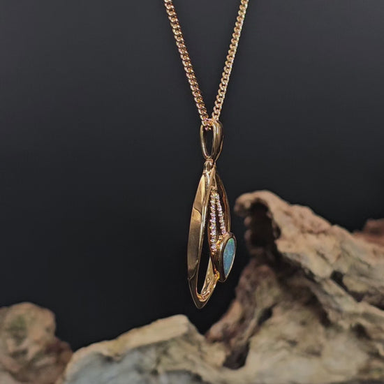 Video showing the gold pendant with black opal and diamonds rotate 200 degrees.