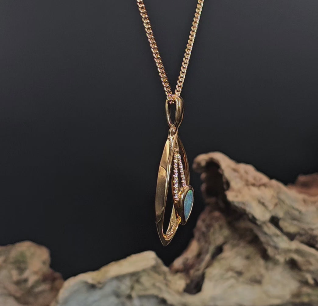 Video showing the gold pendant with black opal and diamonds rotate 200 degrees.