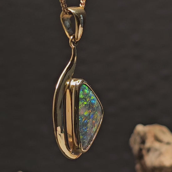 Video showing the gold and opal pendant rotate 180 degrees.
