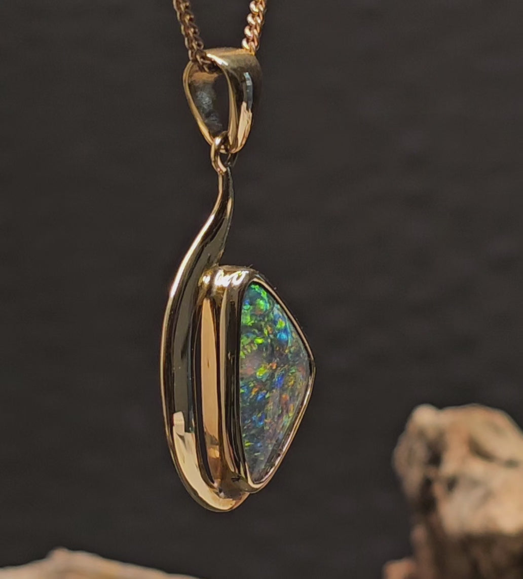 Video showing the gold and opal pendant rotate 180 degrees.