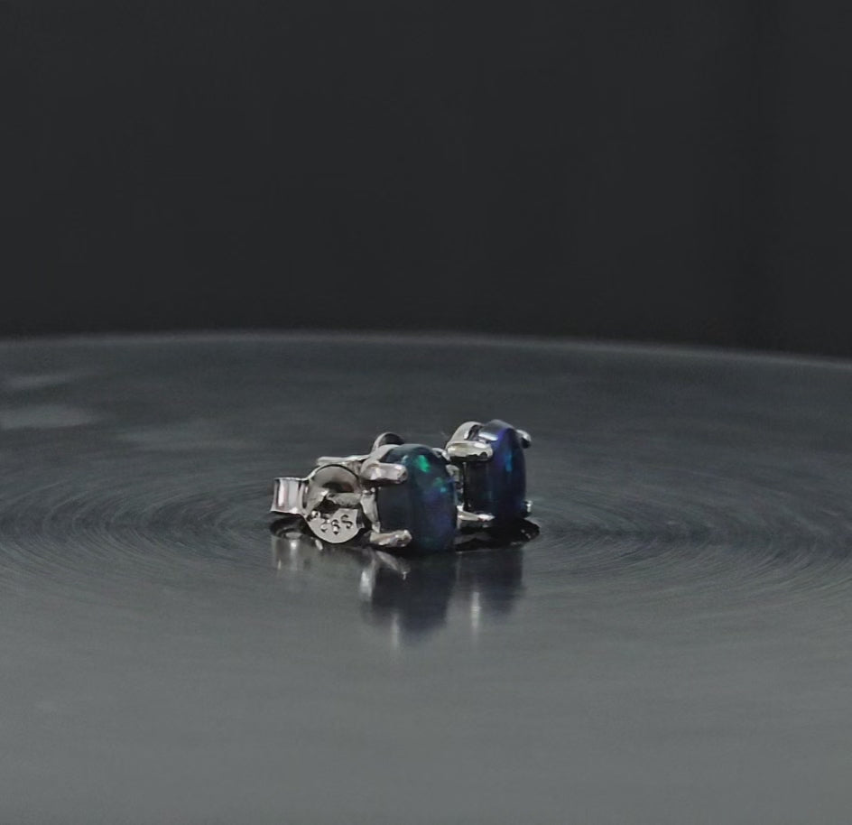 Dark opals set in silver studs shown spinning 180 degrees in this video.