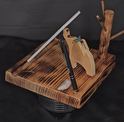 Video showing wooden phone stand with elephant, butterfly, tree-tidy, pen/stylus and white opal specimen rotate giving 180 degree view.