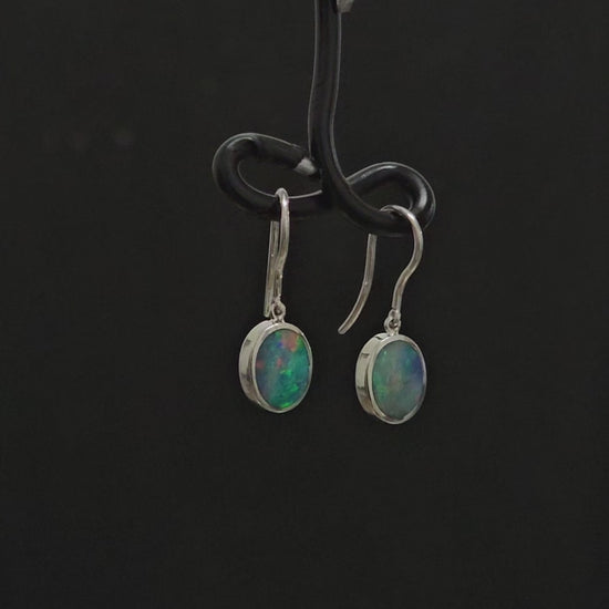 Oval shaped multi-coloured opals in silver shepherd hooks.