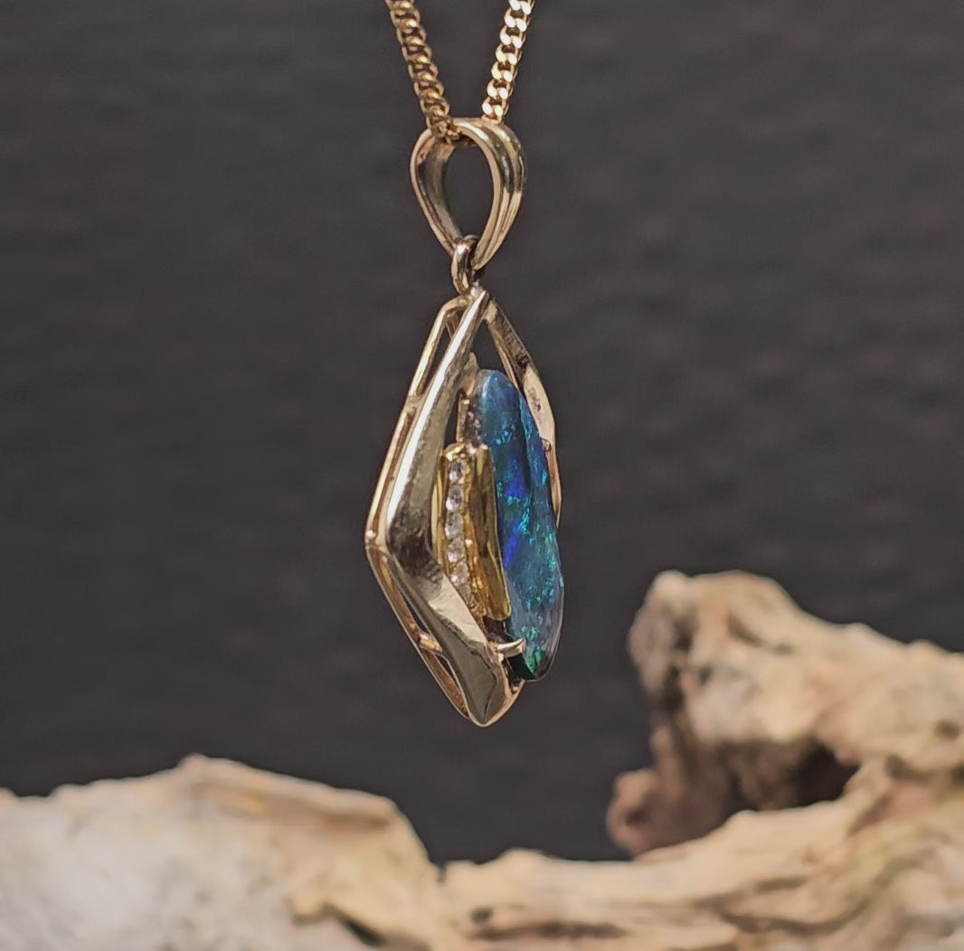 Video showing the gold necklace with black opal and diamonds rotate 180 degrees.