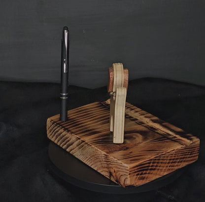 Video showing 360 degree rotation of the wooden phone/tablet stand with wooden dog and black stylus/pen.