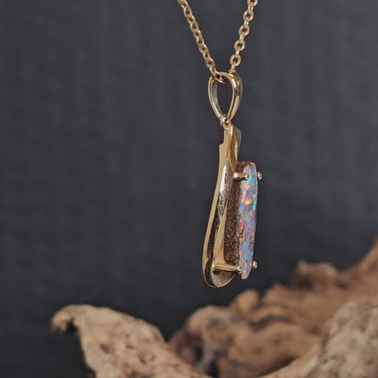 Video showing the yellow gold and boulder opal necklace rotate 180 degrees.