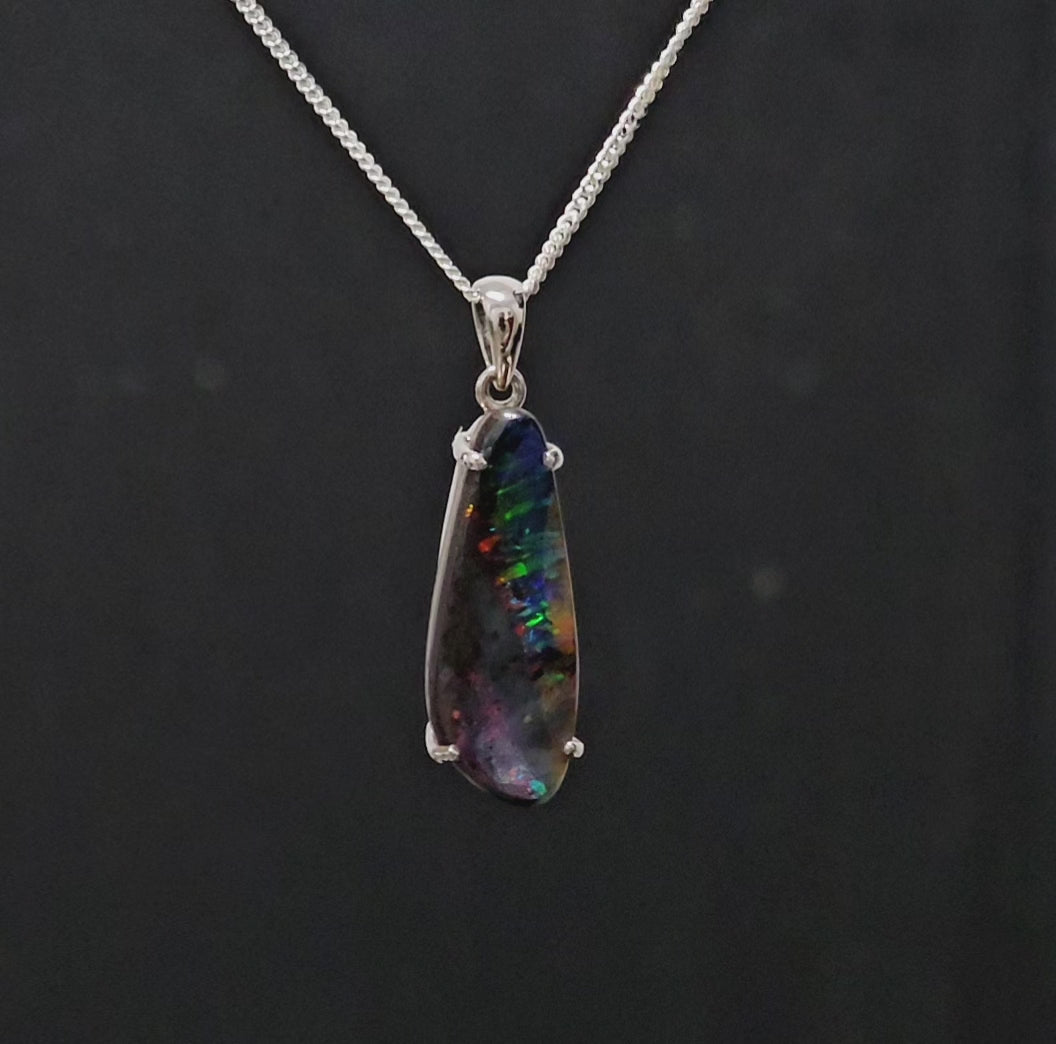 Vibrant and multi-coloured dark opal in silver necklace.